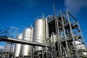 The exterior of a new industrial bio refinery showing pipes, stairs and large distillation tanks