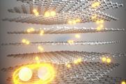 Pairs of orbiting glowing spheres moving through layers of graphene