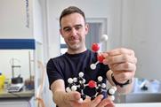 Scientist holding molecule