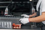 Serviceman repairs electric battery pack of hybrid car
