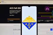 A mobile phone with the ACS logo in front of a computer with the ACS Fall website