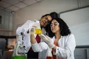 A teacher and student in a practical chemistry class