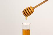 Honey dripping into a test tube