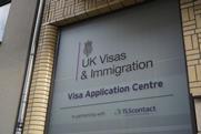 An office building with a sign for UK Visas & Immigration application centre