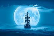 Sailing old ship in a storm sea with full moon stormy clouds in the background