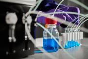 Laboratory photo showing a scientist working with Syris Atlas HD Syringe Pump lab bench equipment