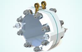 A round flat contraption with bolts around the edge of the flat faces holding a metallic plate in place