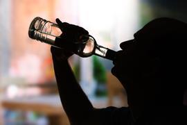 Silhouette of man drinking alcohol