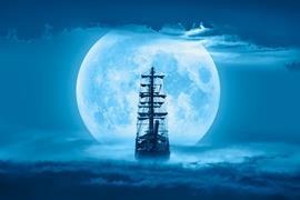 Sailing old ship in a storm sea with full moon stormy clouds in the background