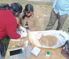 A woman from the Champawat district learning how to use a soil testing device