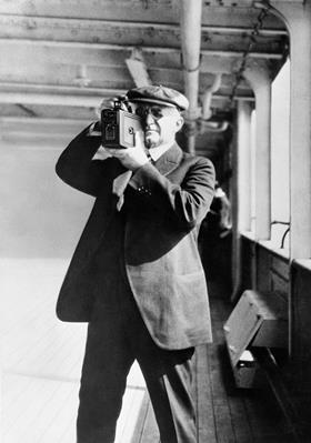 George Eastman, founder of Kodak, taking a photograph