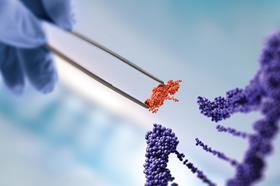 An illustrative image of a gloved hand placing a small part material into a helix