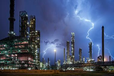 Lightning bolt on top of oil refinery