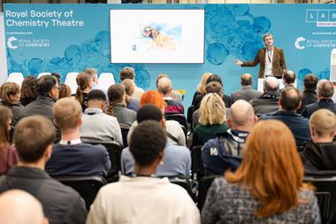 An audience listening to a speaker at a conference