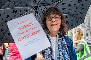 An image showing a woman holding a placard that reads "Without SCIENCE there would be NO CUPCAKES!"