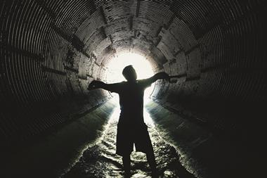 An image showing a silhouette of a man inside a sewer