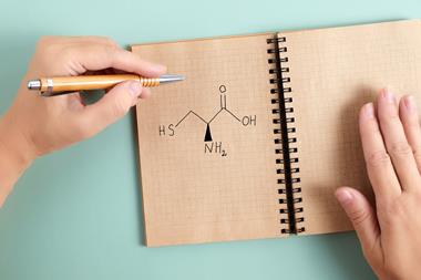 Cysteine with left handed hand holding pen