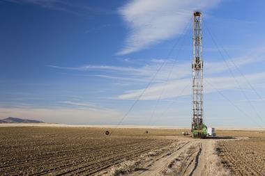 A photograph of a fracking rig and road in a farmer's field