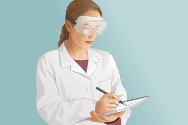 Science laboratory student wearing safety goggles and making notes