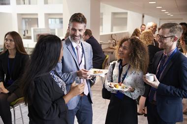 A photograph of people networking at an event