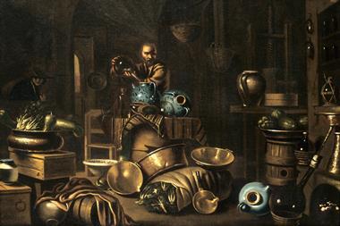 A painting showing an alchemist pouring something from a large flask into a large jar in the middle of a cluttered room