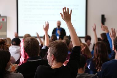 A picture showing students Raising Hands During Seminar