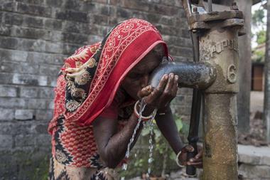 Woman drinking arsenic-contaminated water
