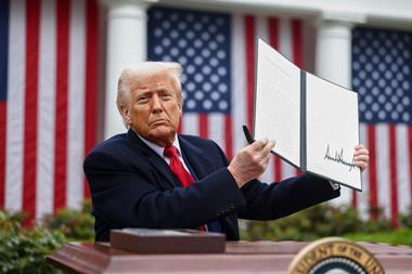 US President Donald Trump displays a signed executive order during a tariff announcement in the Rose Garden of the White House in Washington, DC