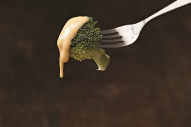 Broccoli dipped in cheese sauce