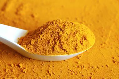 Curcumin longa powder in spoon isolated 