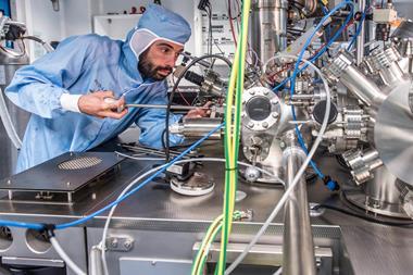 Corentin Durand makes adjustments to the ultrahigh vacuum chamber that houses the nanocar racetrack