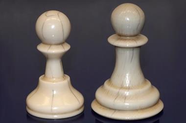 An image showing 3D printed pawns with inked scalpel lines