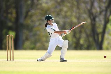 An image showing a woman playing cricket