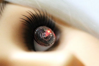 An image showing a photograph of the soft, smart contact lens on an eye of a mannequin