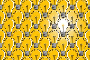 Lit light bulb in a sea of unlit light bulbs