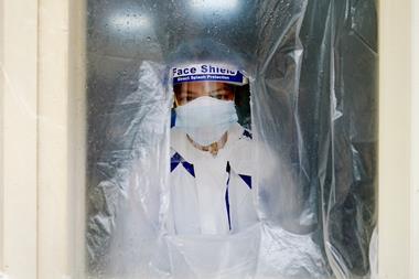 An image showing a health worker wearing personal protective equipment
