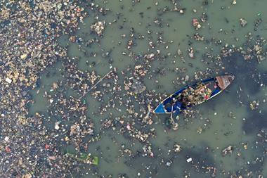 A top view of a boat in the middle of a very polluted river