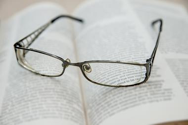 Closeup of reading glasses on the book