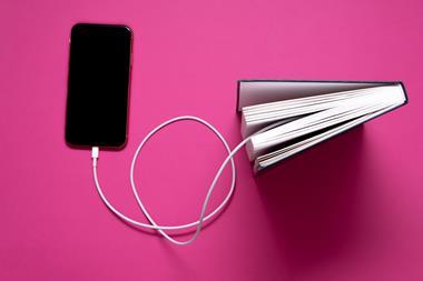 A book, mobile phone & charging cable