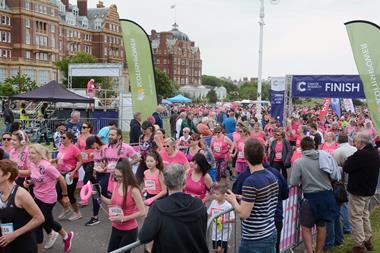 A photo showing runners dressed in pink taking part in a sponsored event for charity