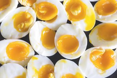 A plate full of medium boiled eggs