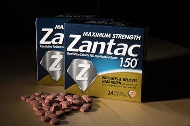 An image showing a photo illustration of a Zantac box and drug tablets