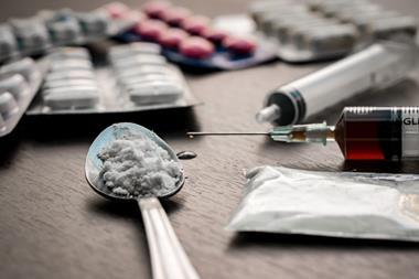 An image of a drug syringe and some cooked heroin on a spoon