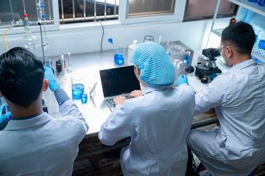 Researchers working side-by-side in the lab