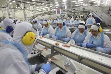 Workers prepare poultry at a meat packing plant in Brazil