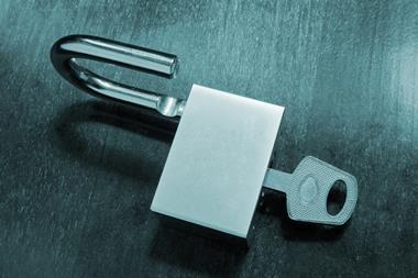 A photo of a key opening a padlock