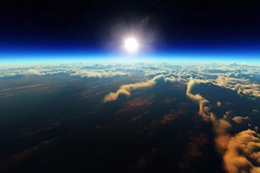 Sunrise over cloudy ocean from outer space