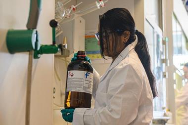 Researcher holding a bottle of DCM