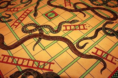 A photo of a vintage snake and ladders board