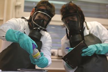 WIS employees testing dummy chemical weapons sample in OPCW laboratory